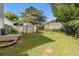 Grassy backyard with a storage shed and a wooden fence, offering a private outdoor space at 4706 Cedar Park Trl, Stone Mountain, GA 30083