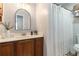 Bathroom featuring a wood vanity, curved mirror, and white shower curtain in a bright and clean space at 4706 Cedar Park Trl, Stone Mountain, GA 30083