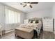 Bedroom with neutral walls, ceiling fan, wood-look floors, and a floral-patterned comforter on a neatly made bed at 4706 Cedar Park Trl, Stone Mountain, GA 30083