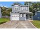 Two-story home featuring an attached garage, inviting curb appeal, and mature trees at 4706 Cedar Park Trl, Stone Mountain, GA 30083