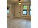 Bright living room features new flooring, freshly painted walls, and a ceiling fan with lights at 1053 Metropolitan Parkway Southwest Sw Pkwy, Atlanta, GA 30310