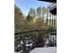 A balcony view shows lush trees and a partial view of cars parked below, providing a sense of nature and urban living at 2840 Peachtree Road Nw Nw Rd # 306, Atlanta, GA 30305