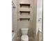 Bathroom featuring a toilet, white subway tile in shower, floating shelves, and contemporary fixtures at 2840 Peachtree Road Nw Nw Rd # 306, Atlanta, GA 30305