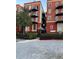 Condominium exterior showcasing its brick facade, black iron balconies, and landscaped entrance with covered walkway at 2840 Peachtree Road Nw Nw Rd # 306, Atlanta, GA 30305
