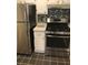 Kitchen featuring stainless steel appliances, white cabinets, and black-and-white backsplash, ideal for cooking at 2840 Peachtree Road Nw Nw Rd # 306, Atlanta, GA 30305