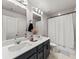 Bathroom with double sinks, modern fixtures, and shower with curtain at 4065 Holland Grove Rd, Lawrenceville, GA 30044