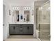 Bathroom featuring double sink vanity with gray cabinets and large glass enclosed shower at 4065 Holland Grove Rd, Lawrenceville, GA 30044