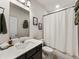 Clean bathroom featuring a vanity with dark cabinets and a shower with a white curtain at 4065 Holland Grove Rd, Lawrenceville, GA 30044