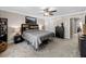 Spacious carpeted bedroom with ceiling fan, bedside tables, and calming decor at 4065 Holland Grove Rd, Lawrenceville, GA 30044