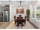 Bright dining room with wood table, modern light fixture, and an abstract art piece at 4065 Holland Grove Rd, Lawrenceville, GA 30044