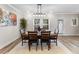 Dining room with seating for six with modern light fixture and an abstract art piece on the wall at 4065 Holland Grove Rd, Lawrenceville, GA 30044