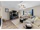 Comfortable living room featuring a large sectional sofa, ceiling fan, and a modern entertainment center at 4065 Holland Grove Rd, Lawrenceville, GA 30044