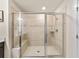 Tiled shower with a glass enclosure and built-in bench at 4065 Holland Grove Rd, Lawrenceville, GA 30044
