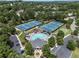 Aerial of community pool and tennis courts surrounded by lush greenery and neighborhood homes at 475 Chippenham Ct, Alpharetta, GA 30005