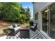 Relaxing backyard patio with comfortable seating, fire pit, and lush greenery at 475 Chippenham Ct, Alpharetta, GA 30005