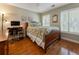 Cozy bedroom with hardwood floors, shuttered windows, and a comfortable bed at 475 Chippenham Ct, Alpharetta, GA 30005