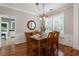 Well-lit dining room boasts hardwood floors and an open layout to the kitchen at 475 Chippenham Ct, Alpharetta, GA 30005