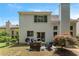 Home exterior featuring a cozy backyard patio with fire pit and grill at 475 Chippenham Ct, Alpharetta, GA 30005