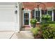 Close-up of the front entrance, showcasing the decorative door and surrounding landscaping at 475 Chippenham Ct, Alpharetta, GA 30005