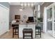 Eat-in kitchen island with granite countertop and seating, sliding doors open to the backyard at 475 Chippenham Ct, Alpharetta, GA 30005