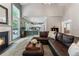 Inviting living room with fireplace, tall ceilings, lots of natural light, and open to kitchen at 475 Chippenham Ct, Alpharetta, GA 30005