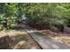 Pathway leading through a wooded area creates a scenic and tranquil experience at 475 Chippenham Ct, Alpharetta, GA 30005