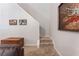 Carpeted stairway ascends past stylish wall art, offering a seamless transition between levels of the home at 475 Chippenham Ct, Alpharetta, GA 30005