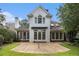 Spacious backyard featuring a large patio and lush green grass, perfect for outdoor entertaining at 6300 Brookside Pl, Roswell, GA 30076