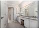 Well-lit bathroom with dual sinks, granite countertops, and updated fixtures at 6300 Brookside Pl, Roswell, GA 30076