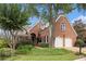 Attractive brick home with a two-car garage and meticulously maintained landscaping at 6300 Brookside Pl, Roswell, GA 30076
