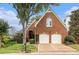 Charming brick home featuring a two-car garage and manicured landscaping at 6300 Brookside Pl, Roswell, GA 30076