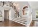 Spacious foyer with staircase, tile flooring, and arched doorway at 6300 Brookside Pl, Roswell, GA 30076
