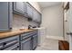 Well-organized laundry room with custom cabinets, countertop, and modern appliances at 6300 Brookside Pl, Roswell, GA 30076