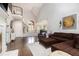 Open-concept living room with hardwood floors and staircase in background at 6300 Brookside Pl, Roswell, GA 30076