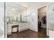 Luxurious main bathroom with marble countertops, dual sinks, and a walk-in closet at 6300 Brookside Pl, Roswell, GA 30076