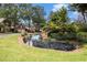 Scenic community pond with a small waterfall and lush landscaping at 6300 Brookside Pl, Roswell, GA 30076