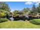 Picturesque community pond with natural rock waterfalls and lush landscaping at 6300 Brookside Pl, Roswell, GA 30076