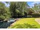 Beautiful community pond featuring small waterfalls and lush greenery, perfect for relaxation at 6300 Brookside Pl, Roswell, GA 30076
