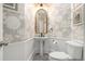 Elegant powder room featuring stylish wallpaper, pedestal sink, and modern fixtures at 6300 Brookside Pl, Roswell, GA 30076