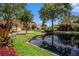 Scenic street view featuring beautiful homes and a tranquil pond at 6300 Brookside Pl, Roswell, GA 30076