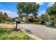 Charming street view with well-maintained landscaping and a scenic pond at 6300 Brookside Pl, Roswell, GA 30076