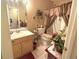 Bathroom featuring a single sink, a toilet, and a shower/tub combination with beautiful curtains at 7133 Babbling Brook Dr, Jonesboro, GA 30236