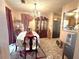 Bright dining area featuring a chandelier, large table with chairs, and view to kitchen at 7133 Babbling Brook Dr, Jonesboro, GA 30236