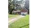 Charming single-story home with a brick facade and well-maintained front yard and a two car garage at 7133 Babbling Brook Dr, Jonesboro, GA 30236