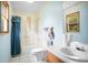 Bright bathroom includes a vanity with a sink, mirror, toilet, and bathtub/shower combination, that requires work at 1587 Cronic Town Rd, Auburn, GA 30011