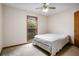 This bedroom features natural light, a ceiling fan, and a bed frame, but is in need of repairs and renovations at 1587 Cronic Town Rd, Auburn, GA 30011