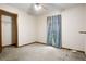 This empty bedroom shows a ceiling fan, closet, and window, but could use some work to make it inviting at 1587 Cronic Town Rd, Auburn, GA 30011