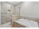 Modern bathroom features a tiled shower and separate soaking tub at 1954 Summit Trace Circle Northwest, Atlanta, GA 30318
