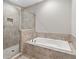 Bathroom featuring a tiled shower and soaking tub at 1954 Summit Trace Circle Northwest, Atlanta, GA 30318