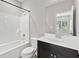 Modern bathroom with a white vanity, a toilet, and a shower-tub combo with contemporary fixtures at 1954 Summit Trace Circle Northwest, Atlanta, GA 30318